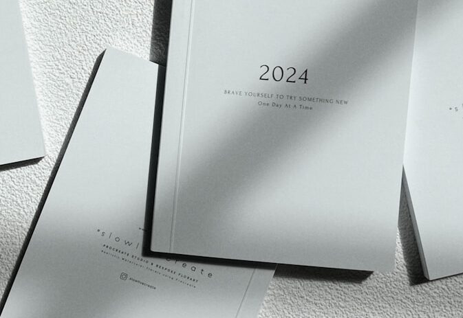 a stack of white books sitting on top of a table